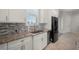 Modern kitchen boasts granite counters, mosaic backsplash, and stainless steel appliances at 3302 Palm Dr, Punta Gorda, FL 33950