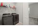 Laundry room with stainless steel washer and dryer and storage shelf at 3302 Palm Dr, Punta Gorda, FL 33950