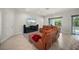 Spacious living room features a comfortable leather sectional and tile flooring at 3302 Palm Dr, Punta Gorda, FL 33950
