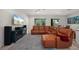 Open-concept living room and dining area featuring comfortable leather seating and modern decor at 3302 Palm Dr, Punta Gorda, FL 33950