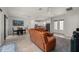 Open-plan living area with leather sectional, dining space and modern kitchen at 3302 Palm Dr, Punta Gorda, FL 33950