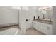 Bathroom featuring double sinks, granite counters, and a soaking tub at 3302 Palm Dr, Punta Gorda, FL 33950