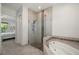 Bathroom featuring a frameless shower, soaking tub, and tile floors at 3302 Palm Dr, Punta Gorda, FL 33950