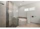 Spa-like bathroom with a large soaking tub and glass shower with pebble accents at 3302 Palm Dr, Punta Gorda, FL 33950