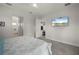 Spacious main bedroom with carpet, a ceiling fan, and a mounted TV at 3302 Palm Dr, Punta Gorda, FL 33950