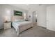 Bright bedroom featuring a king bed, carpet flooring, and modern decor at 3302 Palm Dr, Punta Gorda, FL 33950