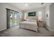Bright main bedroom with a ceiling fan, king bed, and sliding door to the patio at 3302 Palm Dr, Punta Gorda, FL 33950