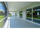 Covered patio with view of lush backyard through the screen and sliding glass doors at 3302 Palm Dr, Punta Gorda, FL 33950