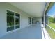 Large screened lanai with a barbecue grill and view of the backyard at 3302 Palm Dr, Punta Gorda, FL 33950