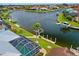 Waterfront home with a screened-in pool area, boat dock, and beautifully landscaped yard at 3353 Sandpiper Dr, Punta Gorda, FL 33950