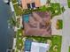 Aerial view of a home featuring a tiled roof, a pool, and mature landscaping at 3353 Sandpiper Dr, Punta Gorda, FL 33950