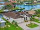 Stunning waterfront home featuring a three-car garage, a tile roof, and manicured landscaping at 3353 Sandpiper Dr, Punta Gorda, FL 33950