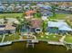 Stunning waterfront property with a screened-in pool, boat dock, and tropical landscaping at 3353 Sandpiper Dr, Punta Gorda, FL 33950