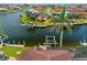 Picturesque waterfront setting with a private boat lift and a screened-in pool area at 3353 Sandpiper Dr, Punta Gorda, FL 33950