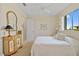 Bedroom features neutral colors, a window with backyard views, and cottage-style furniture at 3353 Sandpiper Dr, Punta Gorda, FL 33950