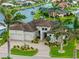 Beautiful waterfront home with a brick driveway, two-car garage, tile roof, and tropical landscaping at 3353 Sandpiper Dr, Punta Gorda, FL 33950
