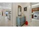 Hallway leading to a kitchen and laundry room with a decorative cabinet at 3353 Sandpiper Dr, Punta Gorda, FL 33950