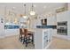 Bright kitchen boasts white cabinets, stainless steel appliances, granite countertops, and a stylish island with seating at 3353 Sandpiper Dr, Punta Gorda, FL 33950