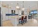 Bright kitchen with pendant lighting, tile backsplash, and a breakfast bar overlooking the dining area at 3353 Sandpiper Dr, Punta Gorda, FL 33950