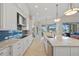 Spacious kitchen features stainless appliances, blue backsplash, granite countertops, and an open view with access to lanai at 3353 Sandpiper Dr, Punta Gorda, FL 33950
