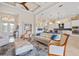Bright living room featuring coffered ceilings and elegant furniture open to kitchen and dining at 3353 Sandpiper Dr, Punta Gorda, FL 33950