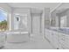 Bright main bathroom boasts a standalone tub, spacious shower, and dual vanities at 3353 Sandpiper Dr, Punta Gorda, FL 33950