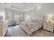 Serene main bedroom with tray ceiling, large windows, and coordinated furnishings at 3353 Sandpiper Dr, Punta Gorda, FL 33950