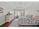 Comfortable main bedroom featuring a tray ceiling, large windows, and coordinated furnishings and decor at 3353 Sandpiper Dr, Punta Gorda, FL 33950