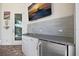 Outdoor kitchen area complete with stainless steel grill and sink, featuring an attractive countertop and tile backsplash at 3353 Sandpiper Dr, Punta Gorda, FL 33950