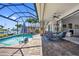 Relaxing screened-in pool area with waterfront views, complete with a lounge area and tropical landscaping at 3353 Sandpiper Dr, Punta Gorda, FL 33950