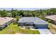 Expansive aerial shot of a well-maintained home with a screened patio and lush green lawn at 336 Waterside St, Port Charlotte, FL 33954