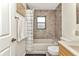 This bathroom offers a shower and tub combination with storage and neutral colors at 336 Waterside St, Port Charlotte, FL 33954