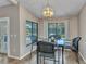 Bright dining area featuring a modern chandelier and views of the pool outside at 336 Waterside St, Port Charlotte, FL 33954