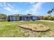 Charming home exterior with rock garden, screened-in porch, and manicured lawn at 336 Waterside St, Port Charlotte, FL 33954