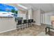 Open-concept kitchen and breakfast bar with sleek white cabinets and modern tile flooring at 336 Waterside St, Port Charlotte, FL 33954
