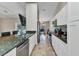 Well-equipped kitchen leading to the dining area, featuring granite countertops and stainless steel appliances at 336 Waterside St, Port Charlotte, FL 33954