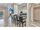 Open kitchen with a breakfast bar overlooking the living area and vaulted ceilings at 336 Waterside St, Port Charlotte, FL 33954