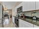 Modern kitchen with granite countertops, stainless steel appliances, and an adjacent dining area at 336 Waterside St, Port Charlotte, FL 33954