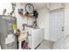 Laundry room with washer, dryer, water heater, utility sink, and storage shelves at 336 Waterside St, Port Charlotte, FL 33954