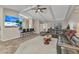 Modern living room featuring tiled floors, a beamed ceiling, and a large sectional sofa at 336 Waterside St, Port Charlotte, FL 33954