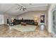Spacious living room with beamed ceilings, tile floors, and a comfortable leather sectional at 336 Waterside St, Port Charlotte, FL 33954