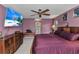Spacious main bedroom with ceiling fan, large dresser, and television for relaxing after a long day at 336 Waterside St, Port Charlotte, FL 33954