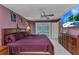 This large main bedroom has outdoor access to the pool, a ceiling fan, and a great TV at 336 Waterside St, Port Charlotte, FL 33954