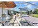 Spacious screened-in patio featuring dining, lounge chairs, and hammock offers a relaxing outdoor retreat at 336 Waterside St, Port Charlotte, FL 33954