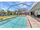 Inviting screened-in pool with patio furniture offers a relaxing space for outdoor living and entertaining at 336 Waterside St, Port Charlotte, FL 33954