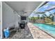 Relaxing screened-in patio and pool with outdoor dining set offers a perfect blend of indoor-outdoor living at 336 Waterside St, Port Charlotte, FL 33954
