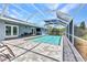 Inviting screened-in pool area with brick pavers and outdoor seating for relaxation and entertaining at 336 Waterside St, Port Charlotte, FL 33954