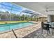 Screened in pool with patio furniture offers a serene backyard retreat perfect for enjoying sunny days at 336 Waterside St, Port Charlotte, FL 33954