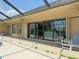 An outdoor porch beside a pool provides relaxing patio furniture under the ceiling fans, with sliding door access at 3398 Tripoli Blvd, Punta Gorda, FL 33950