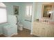 The bathroom provides safety grab bars by the toilet and sink, and a bright window for natural light at 3398 Tripoli Blvd, Punta Gorda, FL 33950